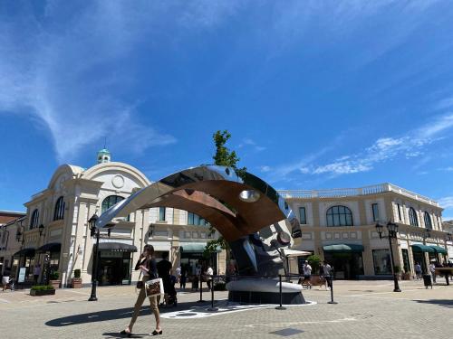 a person riding a skateboard in front of a sculpture at Richmond Vancouver Airport Comfy Home in Richmond