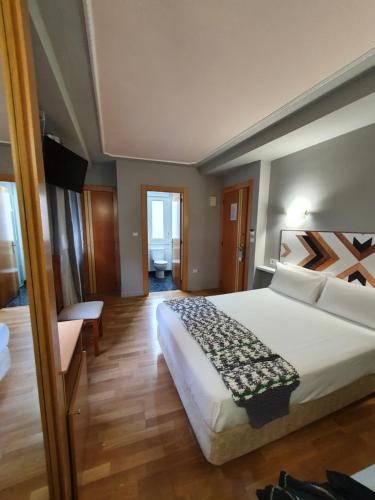 a bedroom with a large white bed in a room at Hotel La Cuesta in Tapia de Casariego