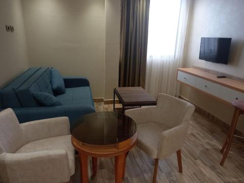 a living room with a couch and chairs and a table at Lego Star Hotel in Addis Ababa