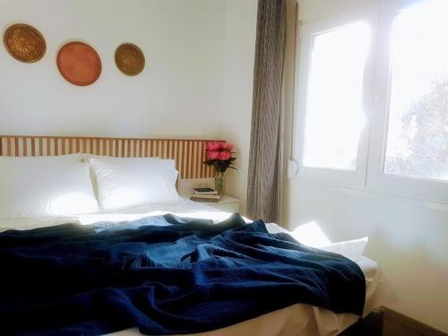 a bed with a blue blanket on it in a bedroom at Spitaki Apartments Potos in Potos