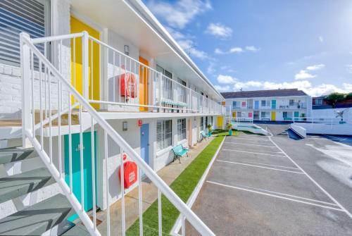 a building with stairs next to a parking lot at Waves on Banyan formerly Comfort Inn International in Warrnambool