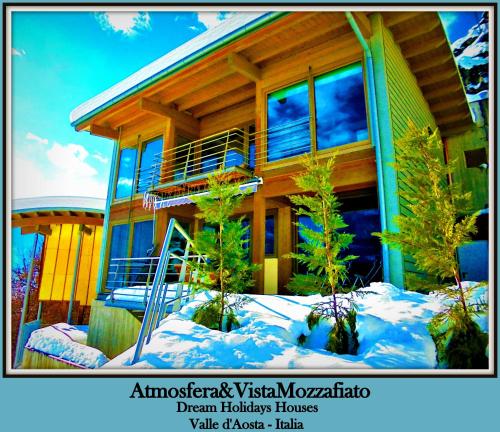 a house with trees in the snow in front of it at CHALET con JACUZZI VISTA MONTAGNE in Aosta
