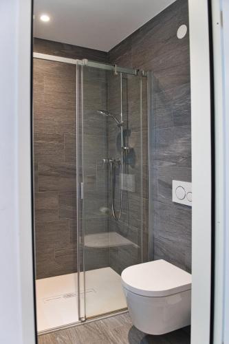 a bathroom with a shower and a toilet at Salotto Brè - Bed & Breakfast charming rooms in Lugano