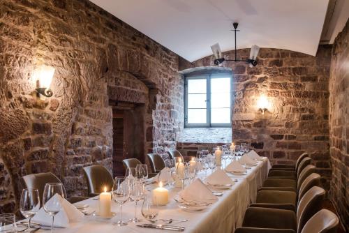 a long table in a room with brick walls at Kloster Hornbach in Hornbach