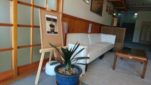 a living room with a couch and a table at Resort Inn Fujihashi in Fujikawaguchiko
