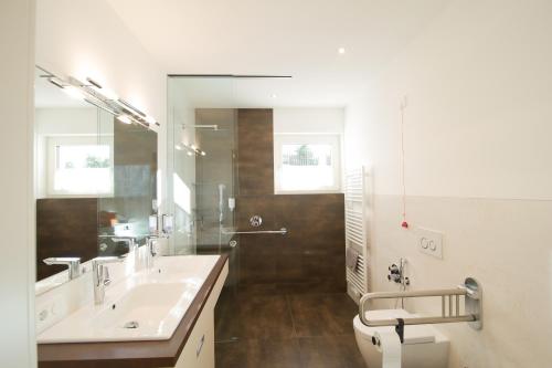 a bathroom with a sink and a toilet and a mirror at Lavendelhof in Appiano sulla Strada del Vino