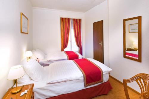 Ein Bett oder Betten in einem Zimmer der Unterkunft Hotel AlaGare