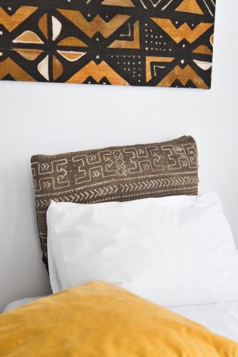 a black and white pillow on top of a bed at Salotto Brè - Bed & Breakfast charming rooms in Lugano