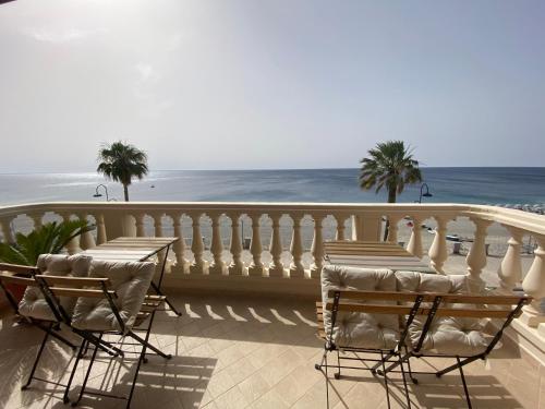 balkon z krzesłami i widokiem na ocean w obiekcie Le Camere di Rosanna w mieście Marina di Gioiosa Ionica