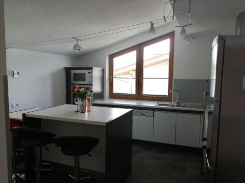 a kitchen with a counter and a sink and a microwave at Apartement Flörl in Rohrberg