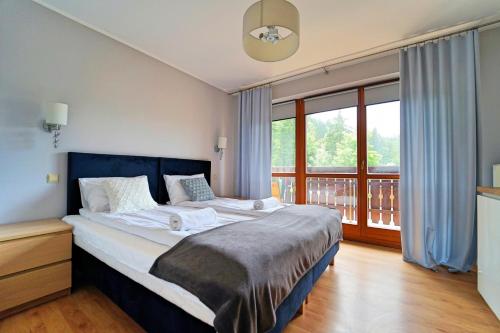 Posteľ alebo postele v izbe v ubytovaní Apartamenty EverySky - Skalna 32