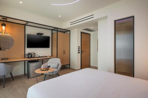 a hotel room with a bed and a desk at Hyperion City Hotel & Spa in Chania Town