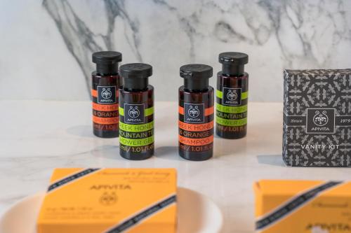 three bottles of essential oils sitting on a table at Hyperion City Hotel & Spa in Chania Town