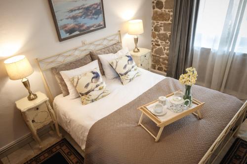 a bedroom with a bed and a table with flowers on it at ΆΘΟΣ (ATHOS) in Nafplio