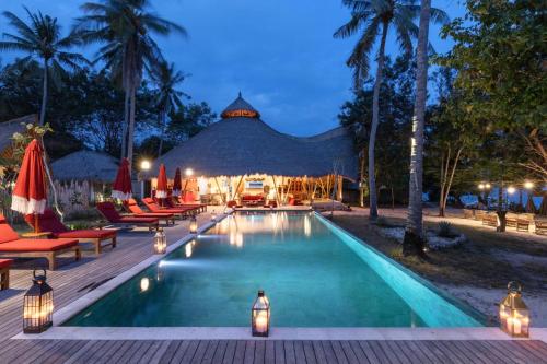 a pool at a resort with chairs and a gazebo at Amahelia Luxury Resort & Restaurant - Gili Asahan in Gili Asahan