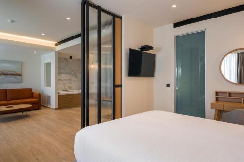 a bedroom with a bed and a living room at Hyperion City Hotel & Spa in Chania Town