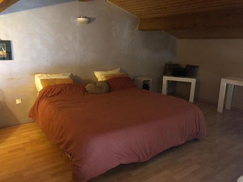 Un dormitorio con una cama con un osito de peluche. en MAISON MEDOC, en Gaillan-en-Médoc