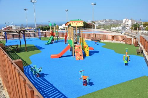 a playground with slides and rides in a park at Vineyards Hill Villa in Megalokhori