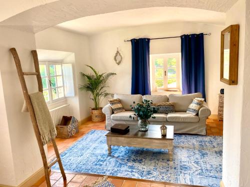 a living room with a couch and a table at L'Effrontée in Tourrettes-sur-Loup