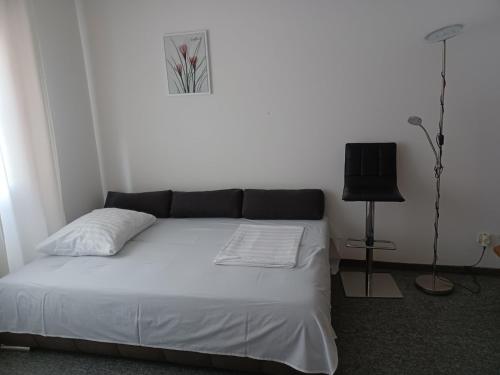 a bedroom with a bed and a television in it at Walk Apartment in Vukovar