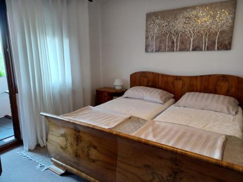a bedroom with two beds and a window at Walk Apartment in Vukovar
