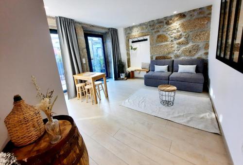 a living room with a blue couch and a table at Lodges Minho in Ponte da Barca