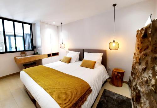 a bedroom with a large bed with a yellow blanket at Lodges Minho in Ponte da Barca