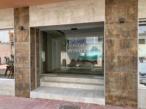 a window of a fashion store with a sign in it at Hostal Rosalia in San Antonio
