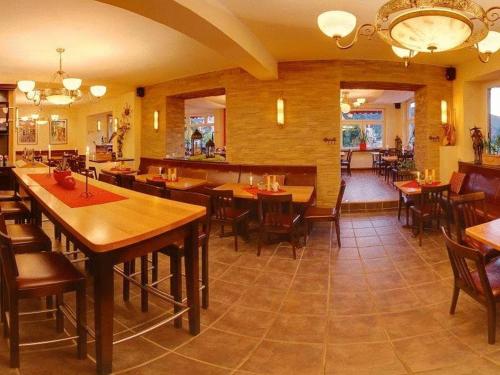 a restaurant with wooden tables and chairs in a room at Stumbergers Hotel in Cochem