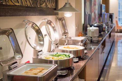 a kitchen with three trays of food on a counter at Norway Forest Villa Motel in Taipei
