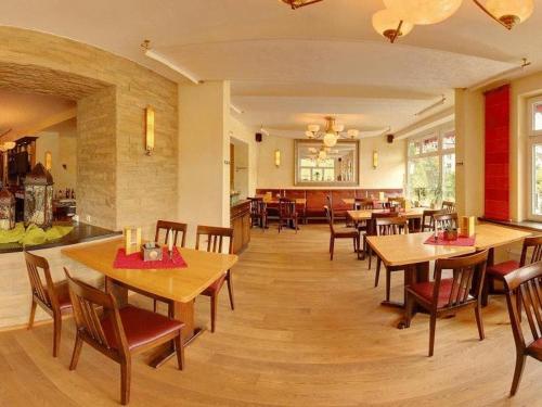 a dining room with wooden tables and chairs at Stumbergers Hotel in Cochem