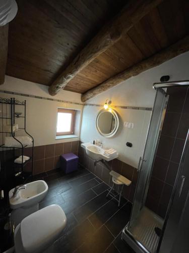 a bathroom with a sink and a shower at Palazzo del Baglivo Cilento Hotel & Spa in Sessa Cilento