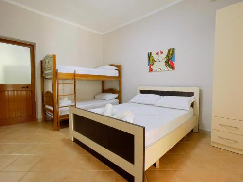 a bedroom with two bunk beds and a mirror at Beach Apartaments in Durrës