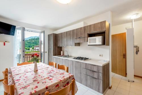 a kitchen and a dining room with a table and chairs at Casa Alberta in Pieve Di Ledro