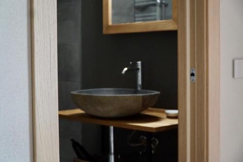 a bathroom with a bowl sink on a counter at Alpi Azzurre in Limone Piemonte