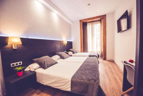 Postel nebo postele na pokoji v ubytování Hostal Marlasca