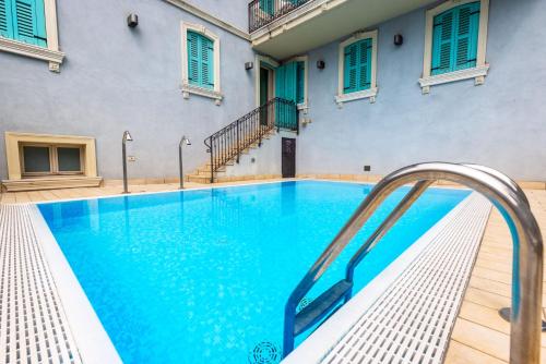 a swimming pool with a blue water slide in a building at Gardone Palace Hotel in Gardone Riviera