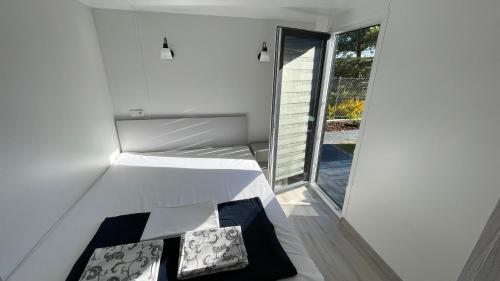 biały pokój z 2 poduszkami i oknem w obiekcie Premium Home Rozewie we Władysławowie