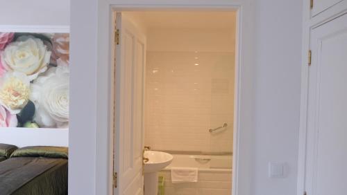 a bathroom with a tub and a toilet and a sink at HOTEL LA CASA DE LAS CAMELIAS in Busto