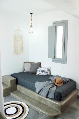 a bedroom with a large bed with a mirror at Aeron Suites in Éxo Goniá