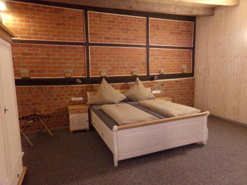 a bedroom with a bed in a brick wall at Zehnthof in Geldersheim