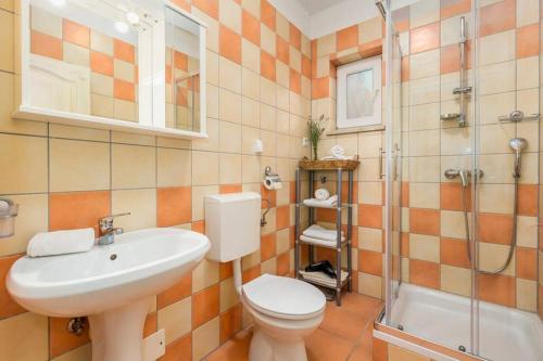 a bathroom with a toilet and a sink and a shower at Villa Lidija in Poreč