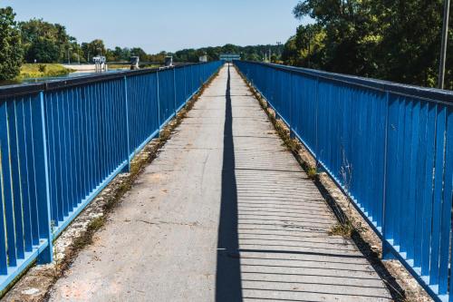 a wooden bridge with a blue fence on it at Apartmány Pulgary in Bulhary