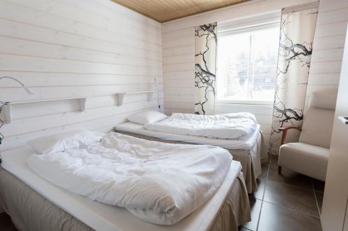 Ranua Resort Holiday Villas tesisinde bir odada yatak veya yataklar