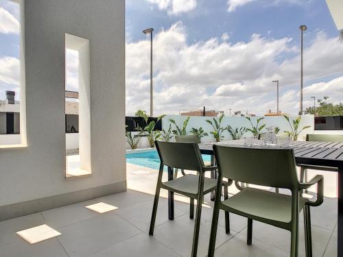 a dining room with a table and chairs on a balcony at Villa sol - Sucina - 3909 in Sucina