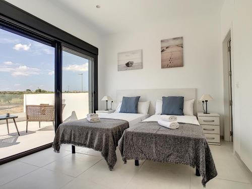 a bedroom with two beds and a large window at Villa sol - Sucina - 3909 in Sucina