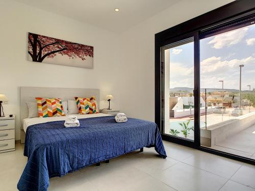 a bedroom with a bed and a large window at Villa sol - Sucina - 3909 in Sucina