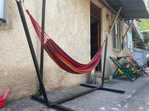 a hammock sitting outside of a building at Hillside Guesthouse in Borjomi