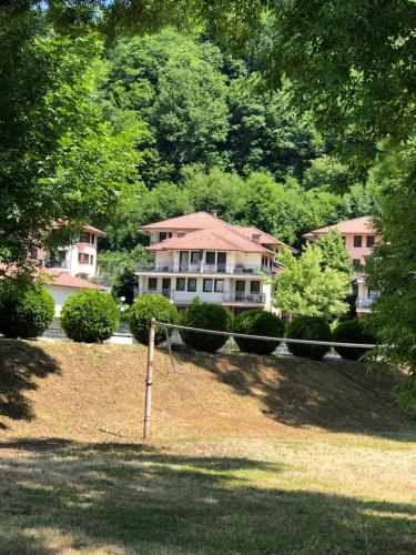 a large house in the middle of a yard at Green Oaza Apartment in Fojnica