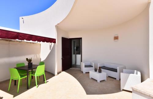 トッレ・デル・オルソにあるDamavi Suite 2のテーブル、椅子、ソファが備わる客室です。